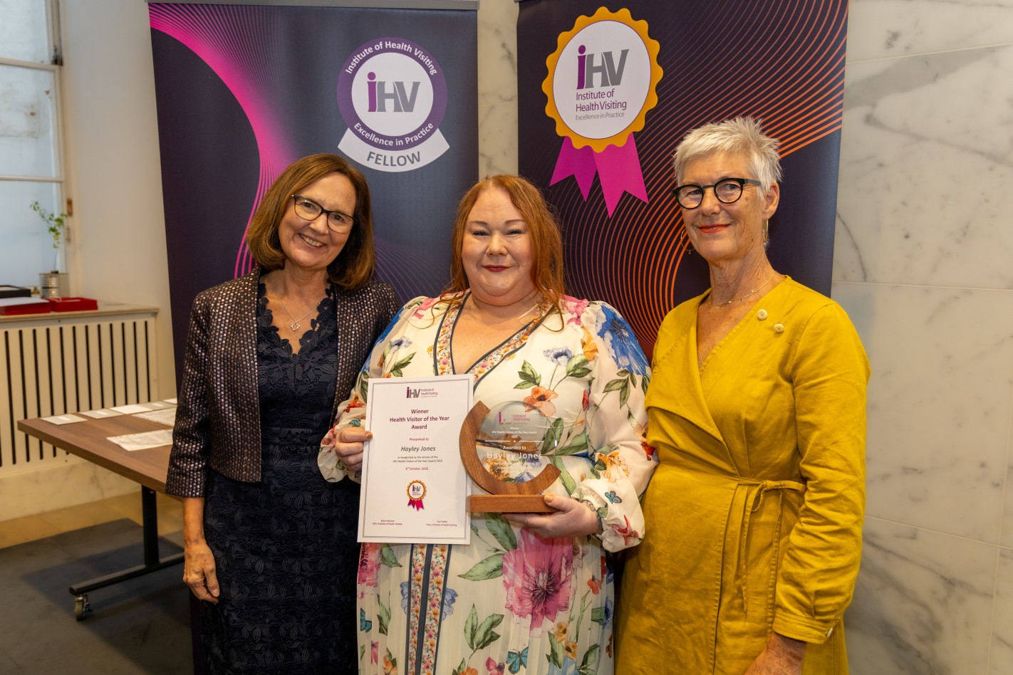 iHV Health Visitor of the Year 2026 award winner Hayley Jones, Senior Nurse in Health Visiting within Aneurin Bevan University Health Board, Wales – with Alison Morton OBE, iHV CEO, and Sue Tokley, iHV Chair