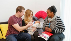 new parents with their health visitor