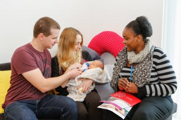 new parents with their health visitor