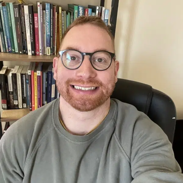 man wearing glasses smiling