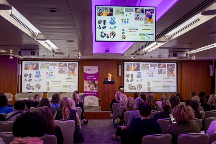 man at lectern presenting to conference audience